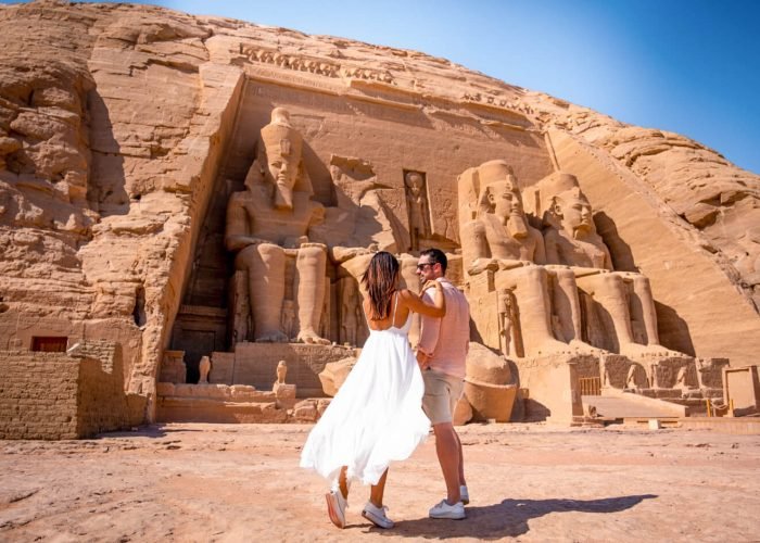a-photo-of-a-couple-in-front-of-abu-simbel-temple-in-aswan