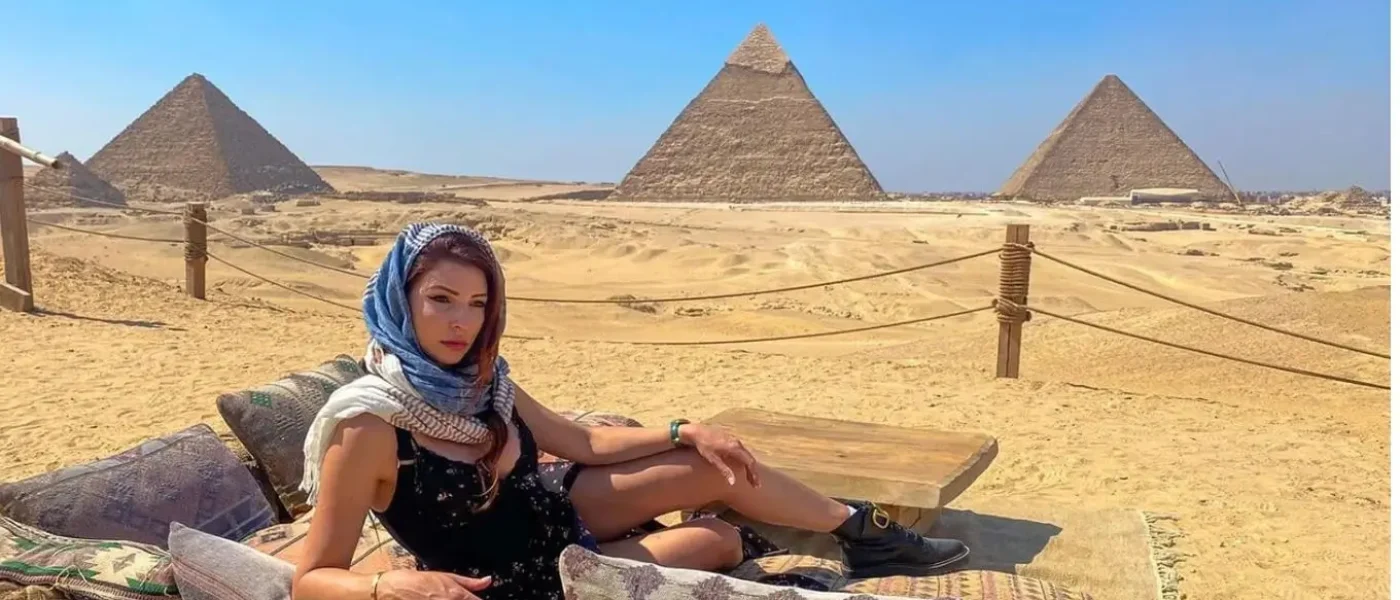 A-woman-lounging-giza-pyramids-viewpoint-cairo
