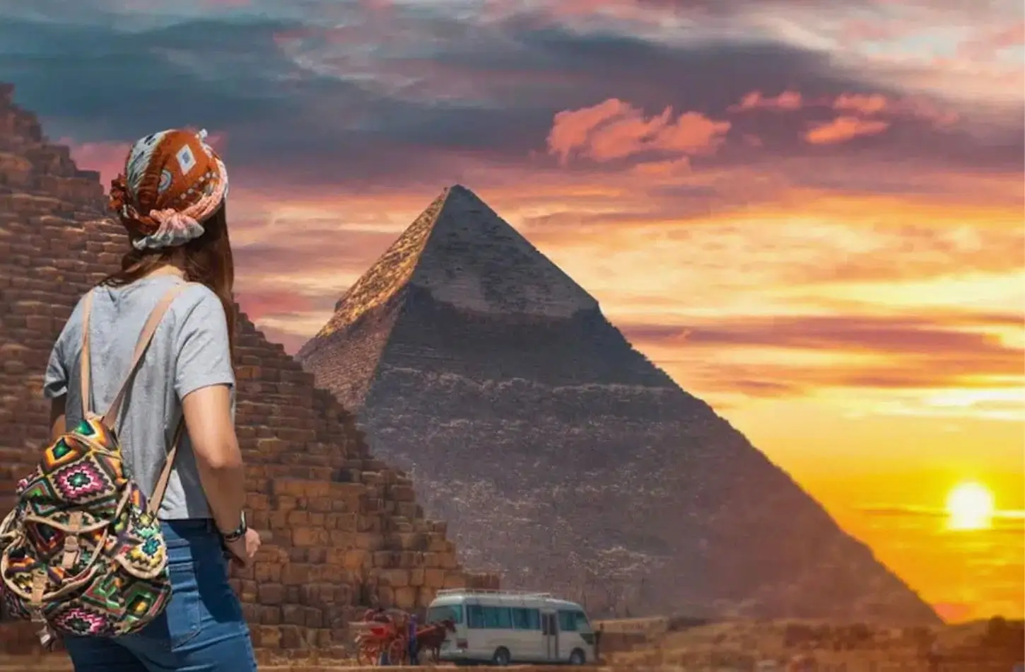 Egypt travel cost per day can vary while visiting iconic sites like the Great Pyramids of Giza, shown here at sunset with a female traveler overlooking the ancient stone structures and a tour bus in the desert.