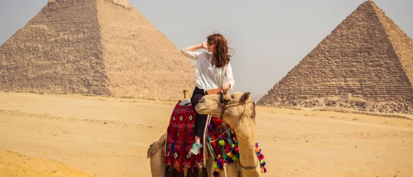 tourist-on-camel-back-cairo-pyramids