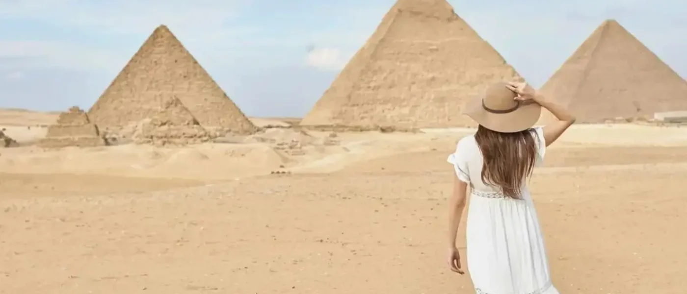 woman-white-dress-giza-pyramids-panoramic-view