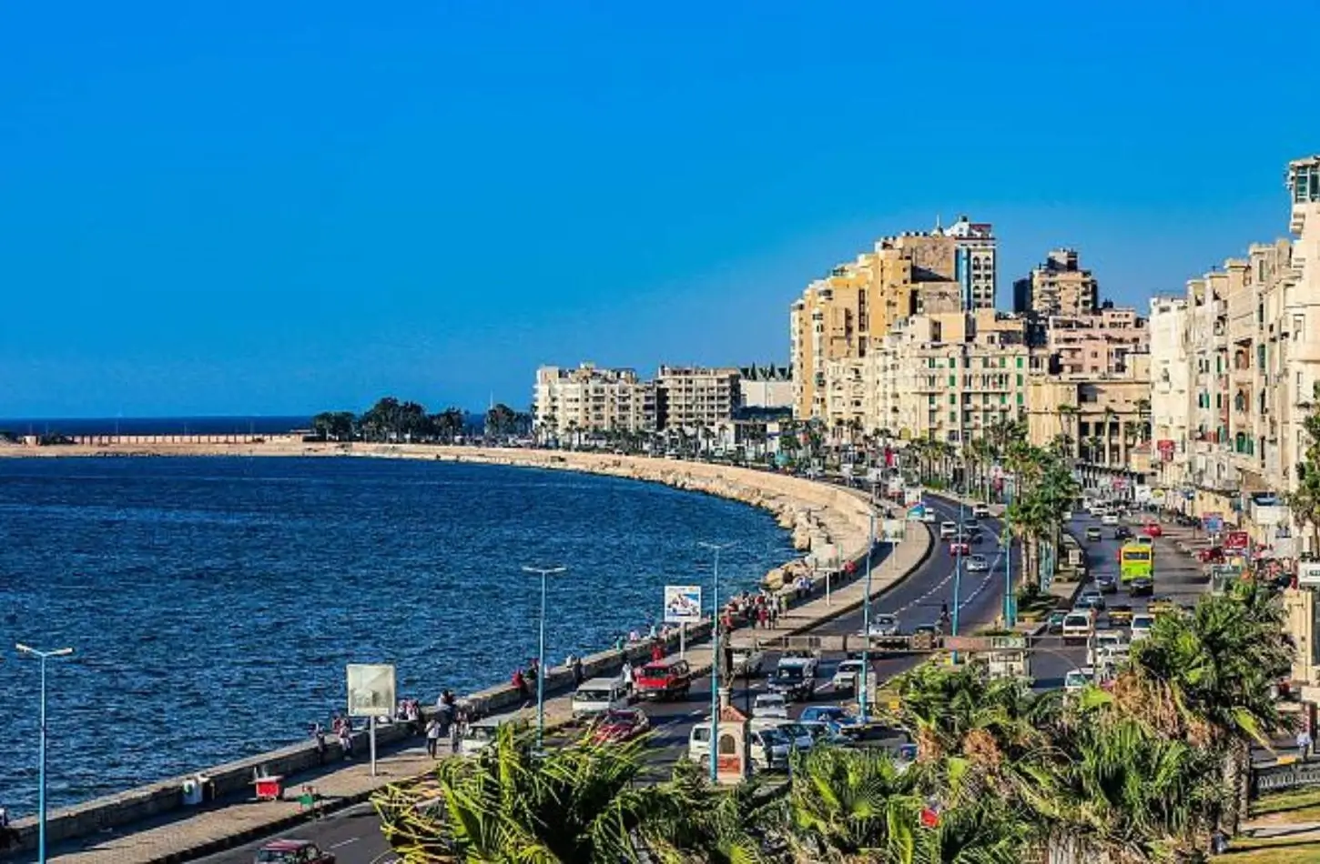 Traffic flowing along the coastal Alexandria Corniche next to the sea, illustrating options for how to get around Egypt.